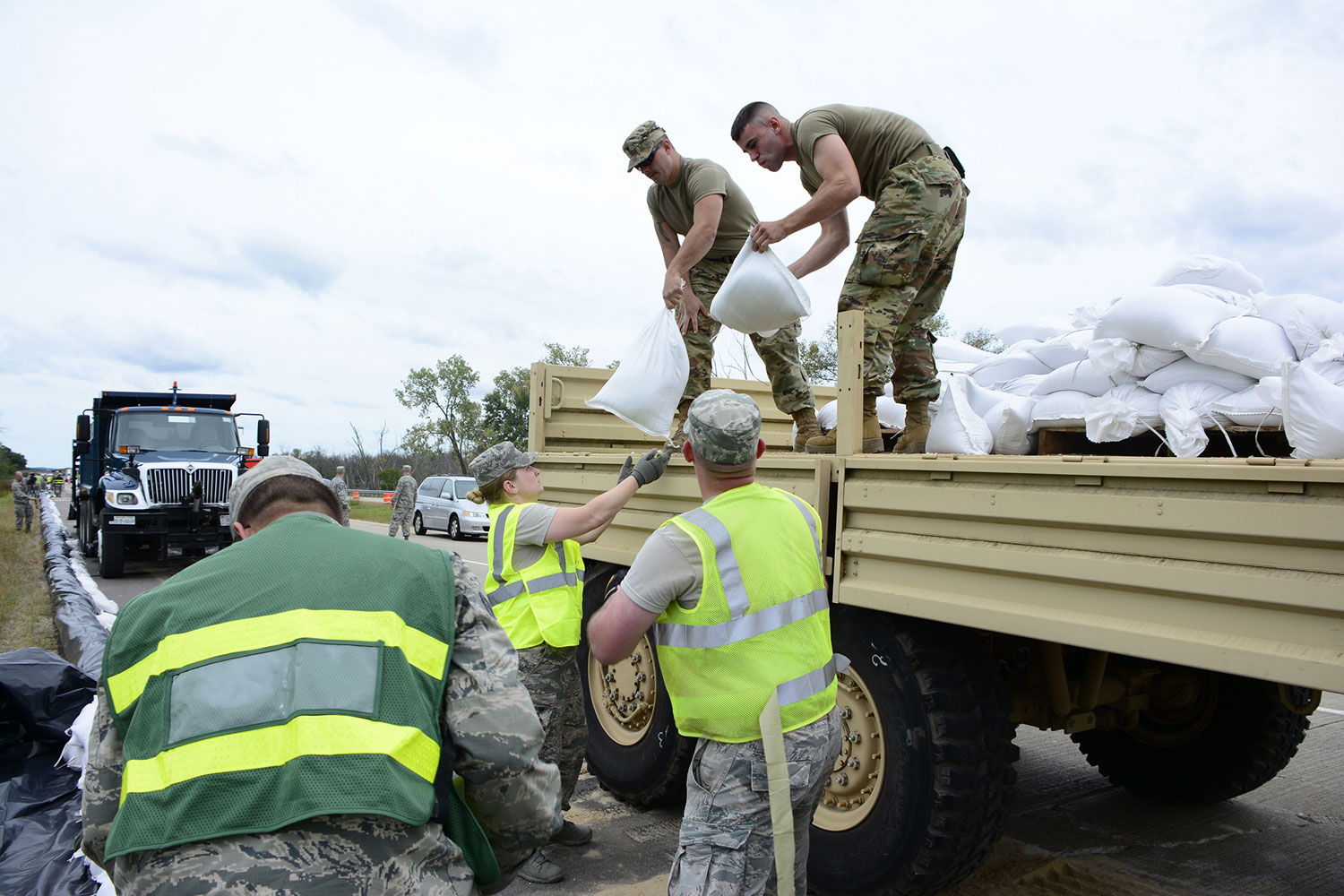 Members of the 115th Fighter Wing provide support by placing sand bags during summer flooding in southern Wisconsin in 2018
