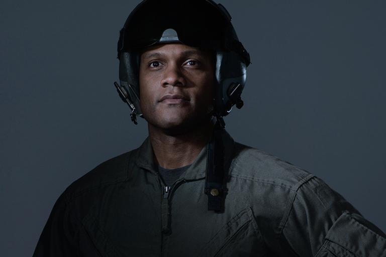 Portrait of a pilot wearing a helmet and jumpsuit
